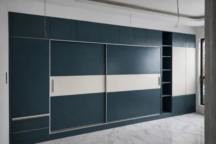 Modern glass sliding door wardrobe design for a bedroom interior in Bangalore