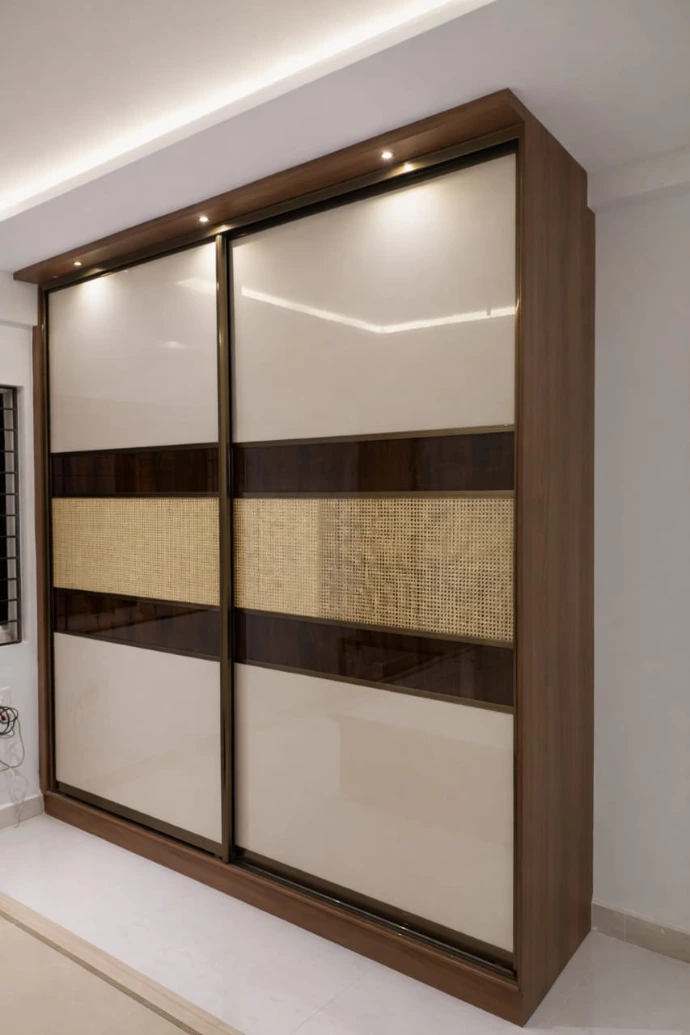 Premium sliding wardrobe design with light wood and glass panels in Bangalore